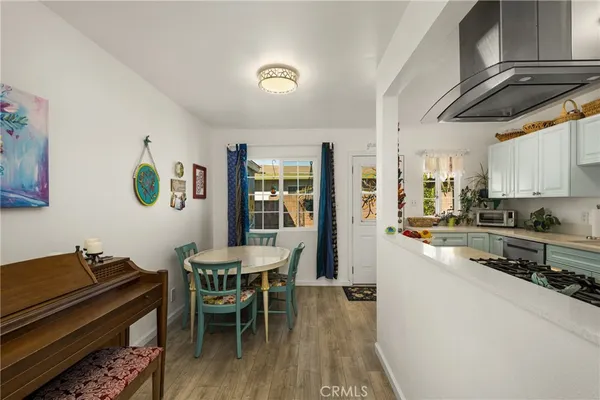 a kitchen with granite countertop a stove a sink and a refrigerator