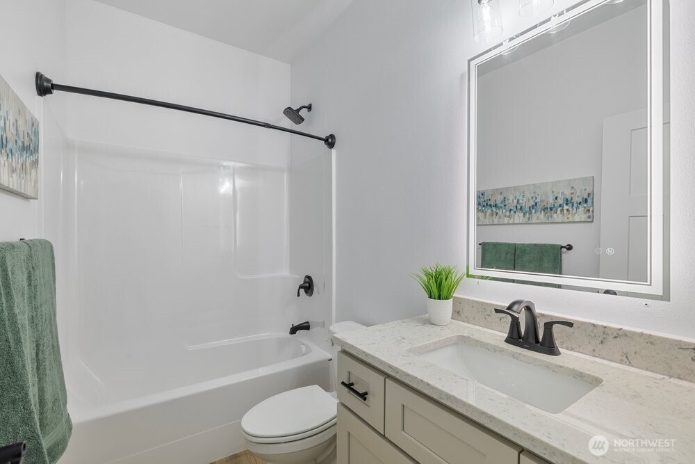334 Spring Circle Mattawa, WA 99349 - Photo 22 of 40 a bathroom with a granite countertop bathtub shower sink vanity mirror and toilet