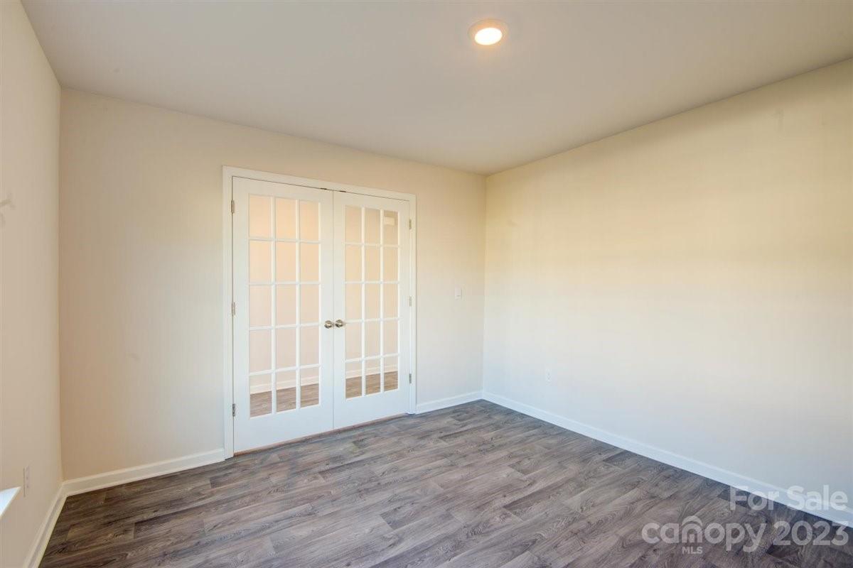 220 Jackson Way Lexington, NC 27295 - Photo 3 of 33 a view of an empty room with wooden floor and a window