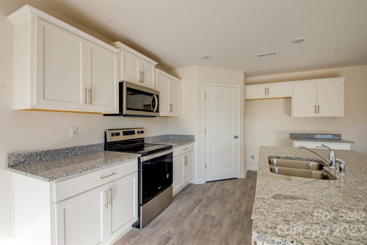 220 Jackson Way Lexington, NC 27295 - Photo 32 of 33 a kitchen with granite countertop cabinets stainless steel appliances and a counter space