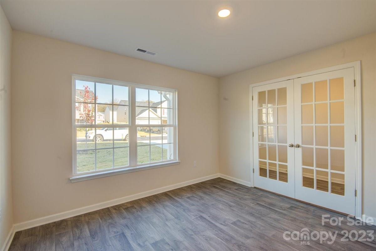 220 Jackson Way Lexington, NC 27295 - Photo 4 of 33 a view of an empty room with wooden floor and windows