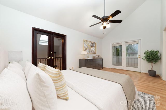 a bedroom with a large bed and a window