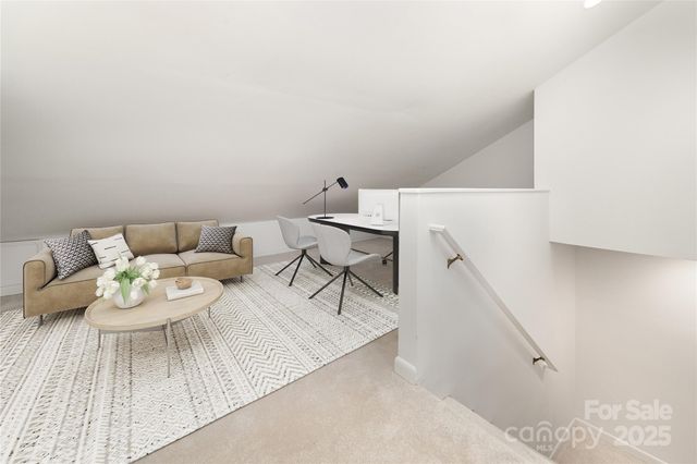 a view of a dining room with furniture and a rug