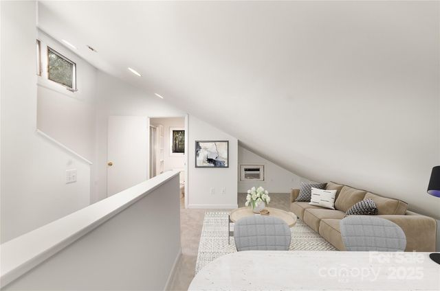 a living room with furniture and stairs