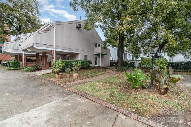 a house that has a tree in front of it