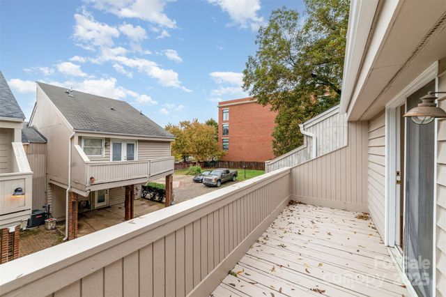 a view of a house with wooden fence