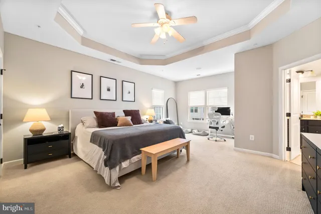 a spacious bedroom with a bed and a chandelier
