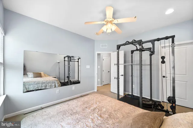 a bathroom with a granite countertop sink a toilet and a mirror