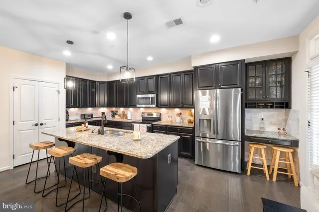 a kitchen with granite countertop a sink and a stove