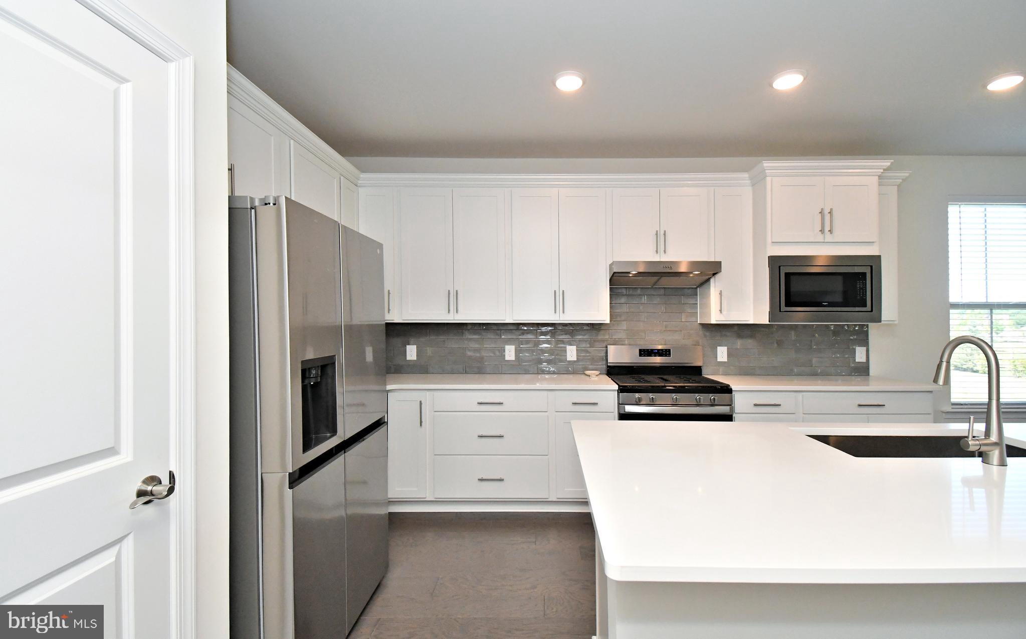 1024 Wright Street Hatfield, PA 19440 - Photo 6 of 68 a kitchen with stainless steel appliances a stove a sink a refrigerator white cabinets and a refrigerator