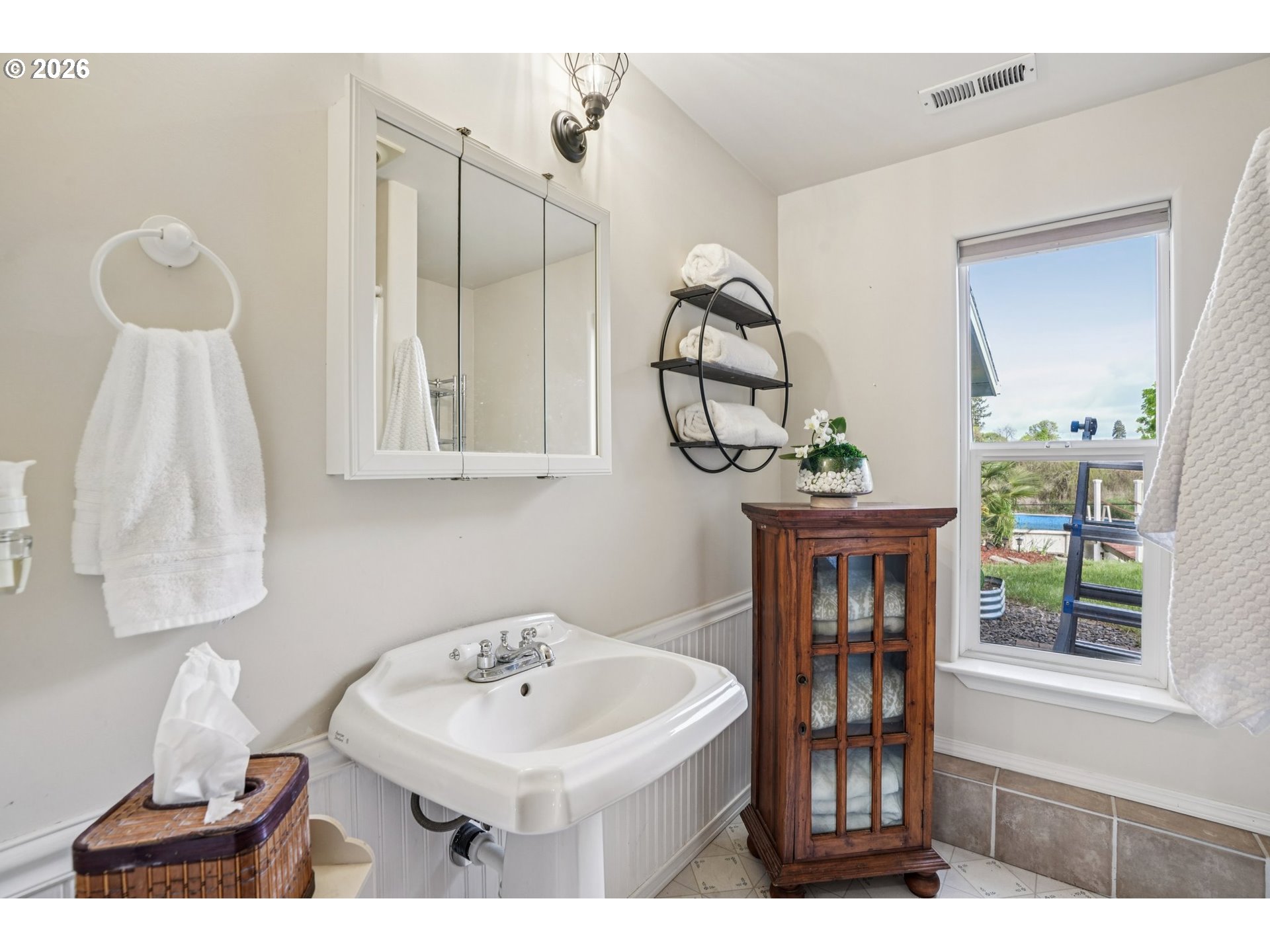 128 North 31st Avenue Cornelius, OR 97113 - Photo 16 of 32 a bathroom with a sink a mirror and a window