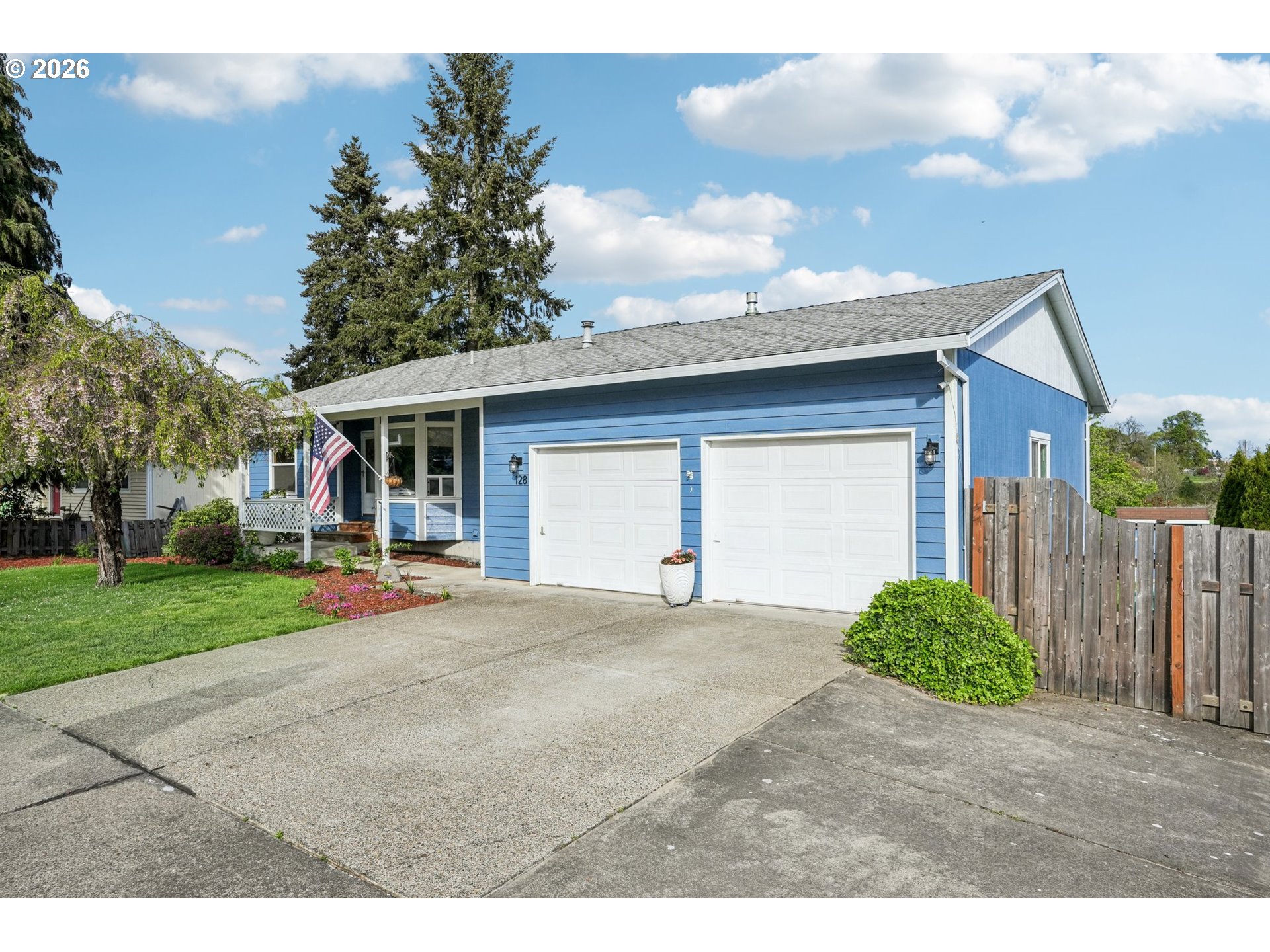 128 North 31st Avenue Cornelius, OR 97113 - Photo 2 of 32 a front view of a house with a yard and garage