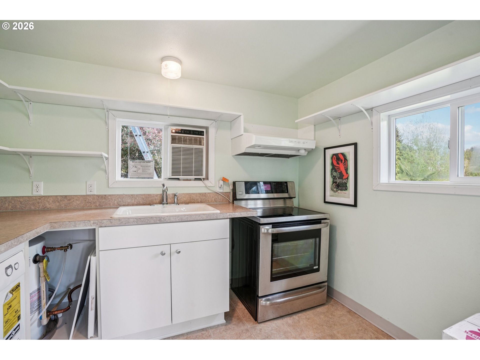128 North 31st Avenue Cornelius, OR 97113 - Photo 21 of 32 a kitchen with stainless steel appliances granite countertop a stove a sink and a microwave