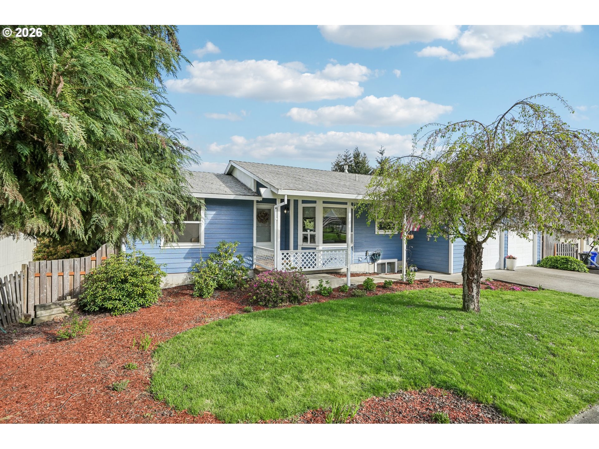 128 North 31st Avenue Cornelius, OR 97113 - Photo 3 of 32 a front view of a house with a garden and trees
