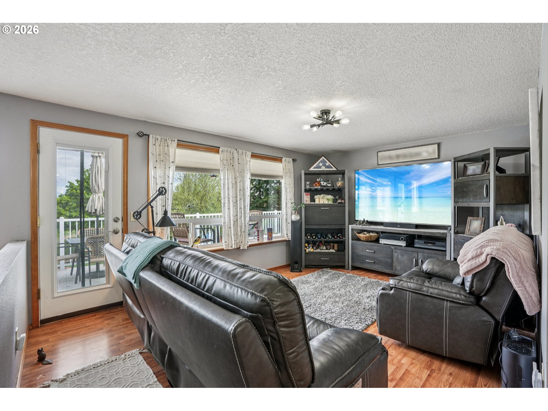 128 North 31st Avenue Cornelius, OR 97113 - Photo 5 of 32 a living room with furniture a large window and flat screen tv