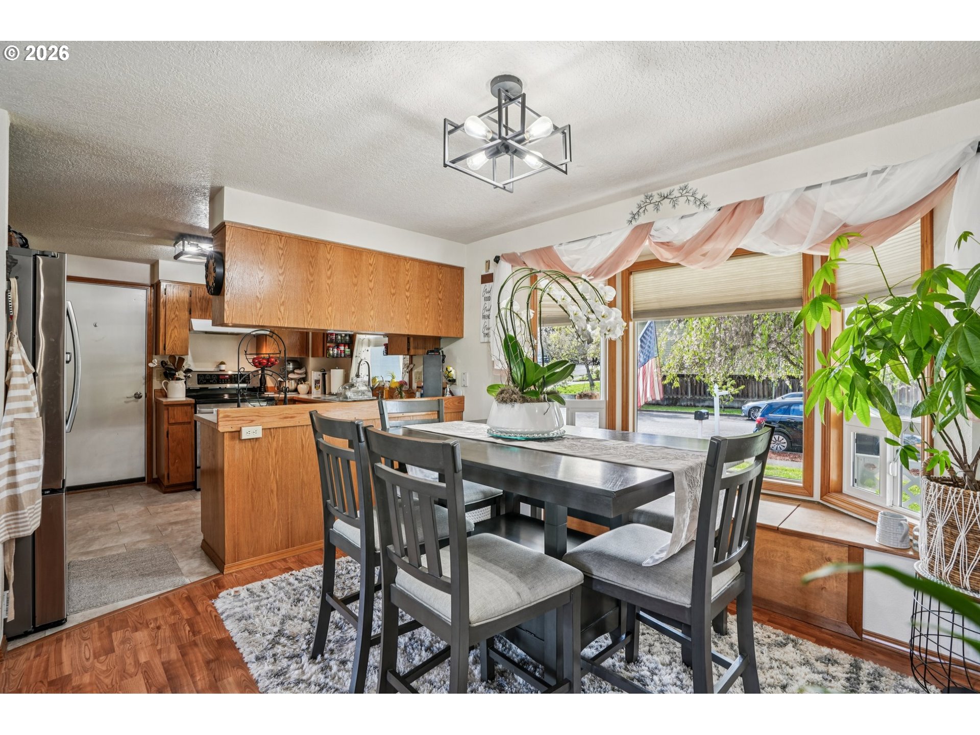 128 North 31st Avenue Cornelius, OR 97113 - Photo 7 of 32 a dining room with furniture a chandelier and wooden floor