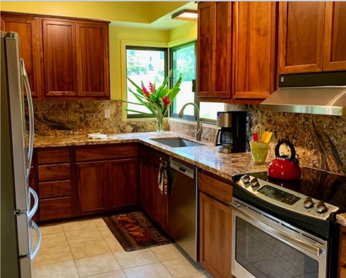 60 Kalo Road Hana, HI 96713 - Photo 8 of 30 a kitchen with stainless steel appliances a stove a sink and a microwave