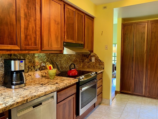 60 Kalo Road Hana, HI 96713 - Photo 9 of 30 a kitchen with stainless steel appliances granite countertop wooden cabinets and a sink
