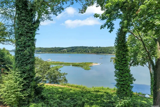 an aerial view of a houses with outdoor space and lake view