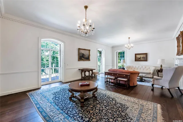 a living room with furniture a window and a chandelier