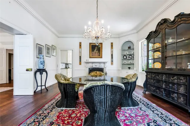 a dining room with furniture a rug and wooden floor