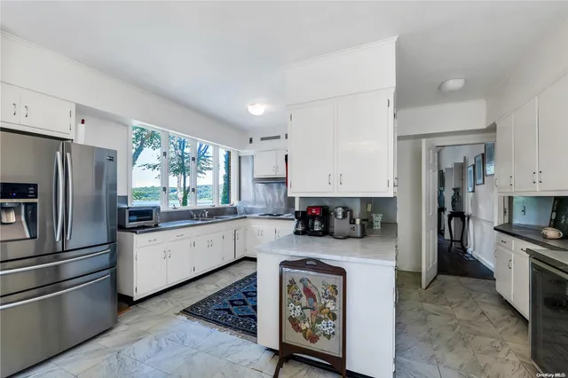 a kitchen with refrigerator and cabinets