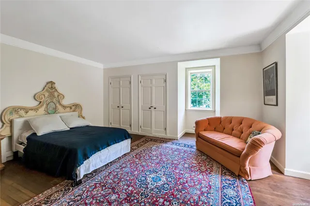 a bedroom with a bed couch and window