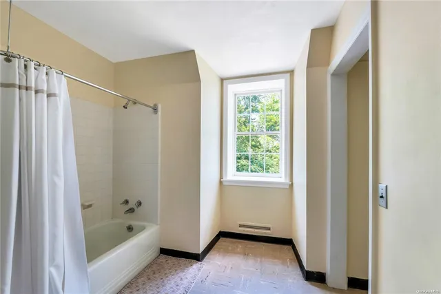 a bathroom with a tub a sink and a shower