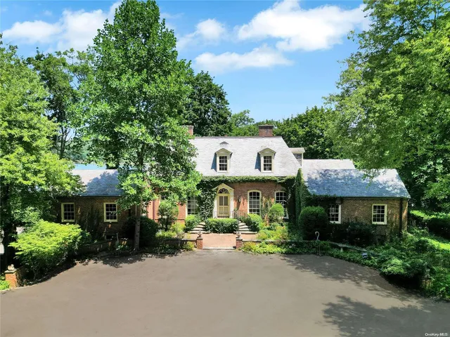 a view of a house with a yard and potted plants