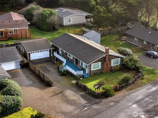 an aerial view of a house with a yard table and chairs