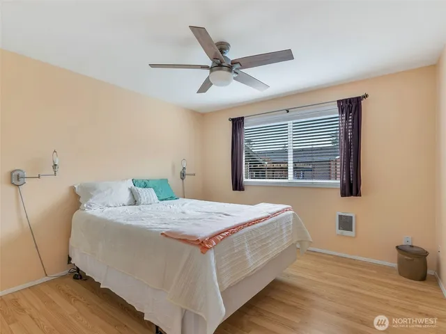 a bedroom with a bed and a ceiling fan
