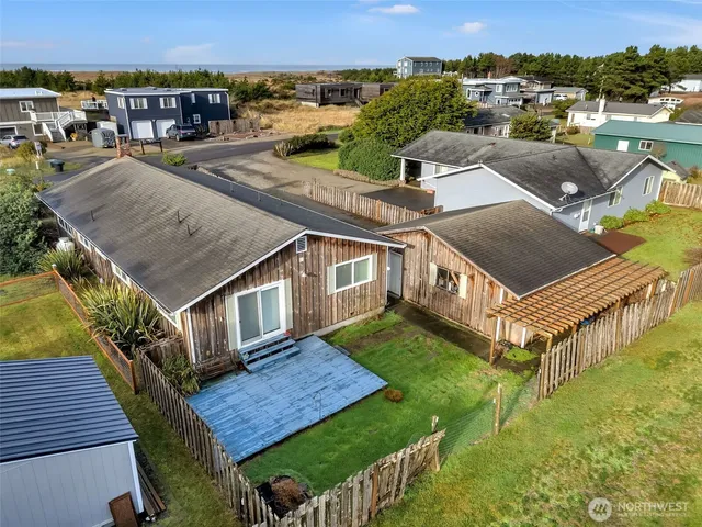 an aerial view of a house with a yard