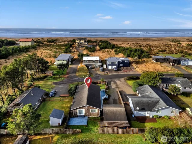 an aerial view of a yard with swimming pool and outdoor seating