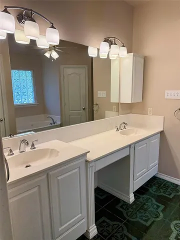 a bathroom with a sink vanity and a mirror