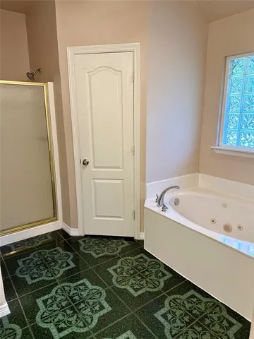 a bathroom with a bathtub and a shower