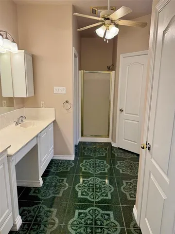 a bathroom with a sink a mirror and a shower