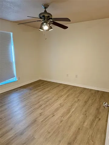 a view of a room with wooden floor and white walls