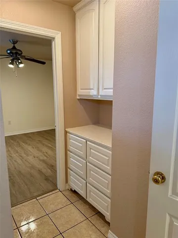 an empty room with wooden floor and staircase
