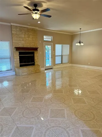 a view of an empty room with a fireplace and a window