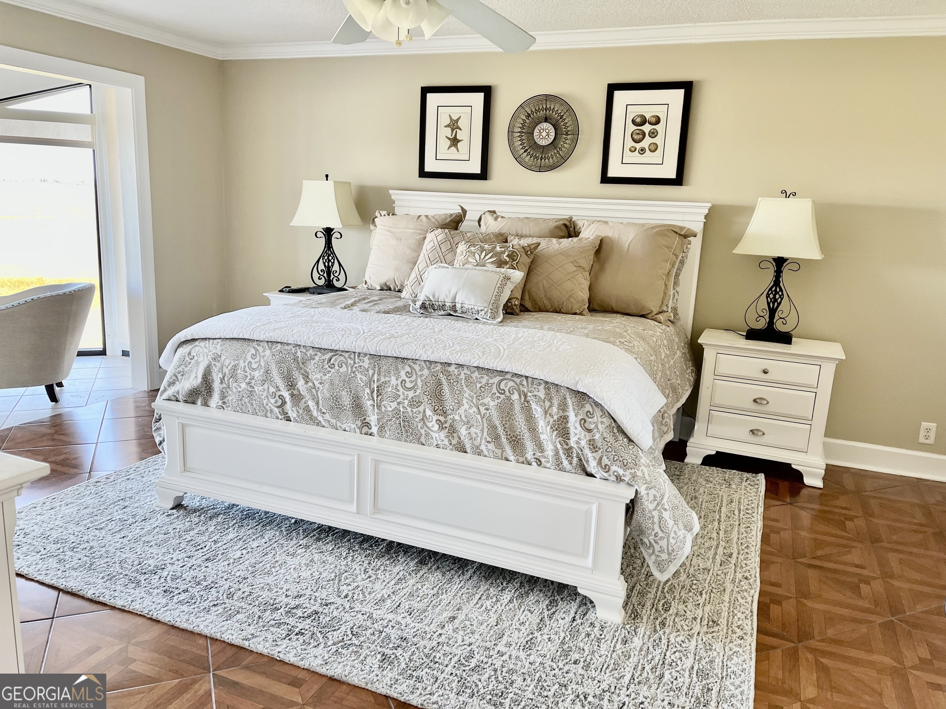 372 Moss Oak Circle St. Simons, GA 31522 - Photo 11 of 44 a spacious bedroom with a bed and lamp