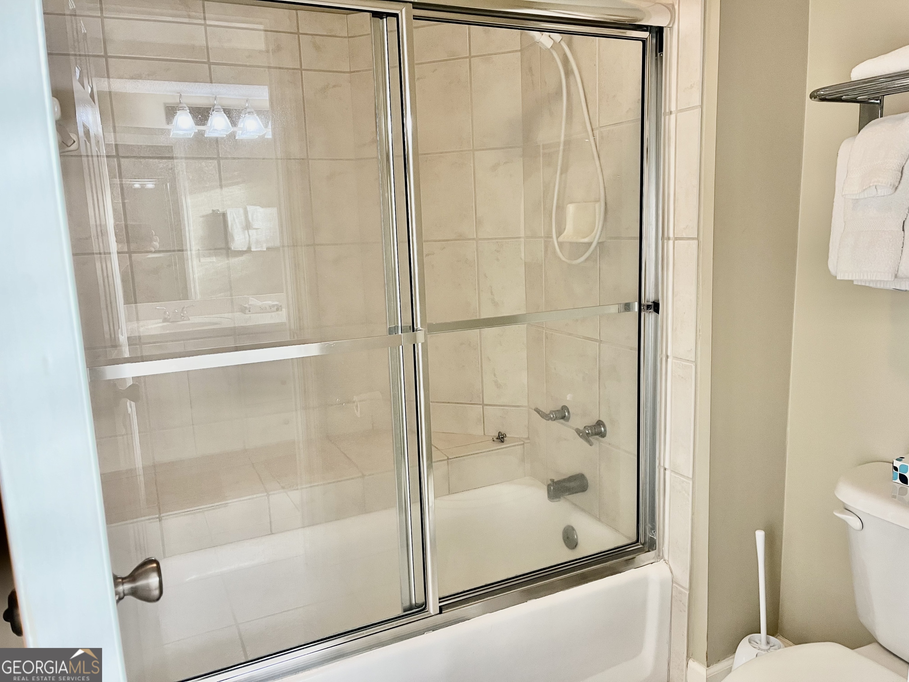 372 Moss Oak Circle St. Simons, GA 31522 - Photo 17 of 44 a bathroom with a glass shower door