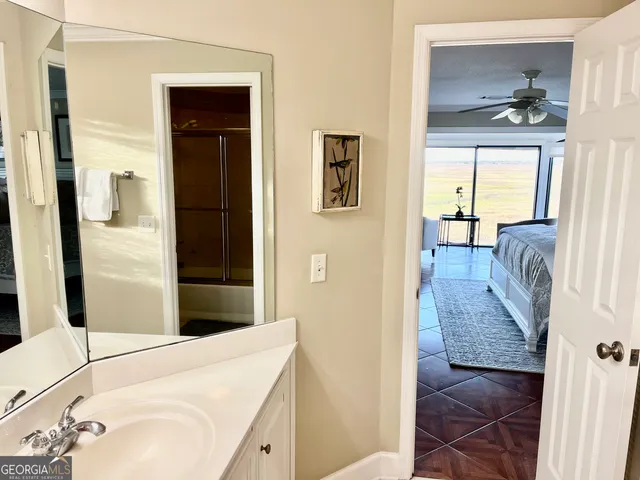 a view of a bedroom with wooden floor and bed