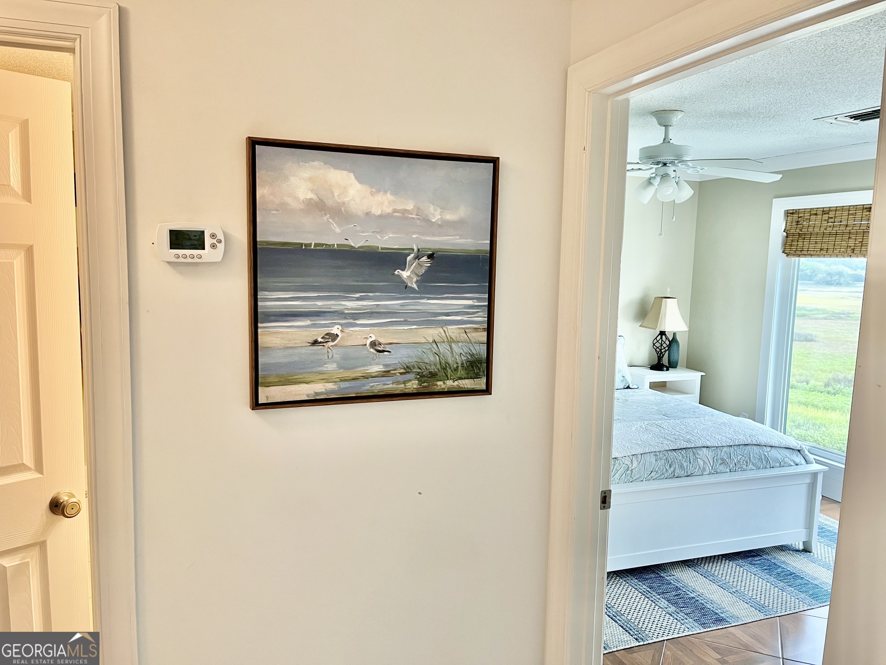 372 Moss Oak Circle St. Simons, GA 31522 - Photo 19 of 44 a view of a bedroom with wooden floor and bed