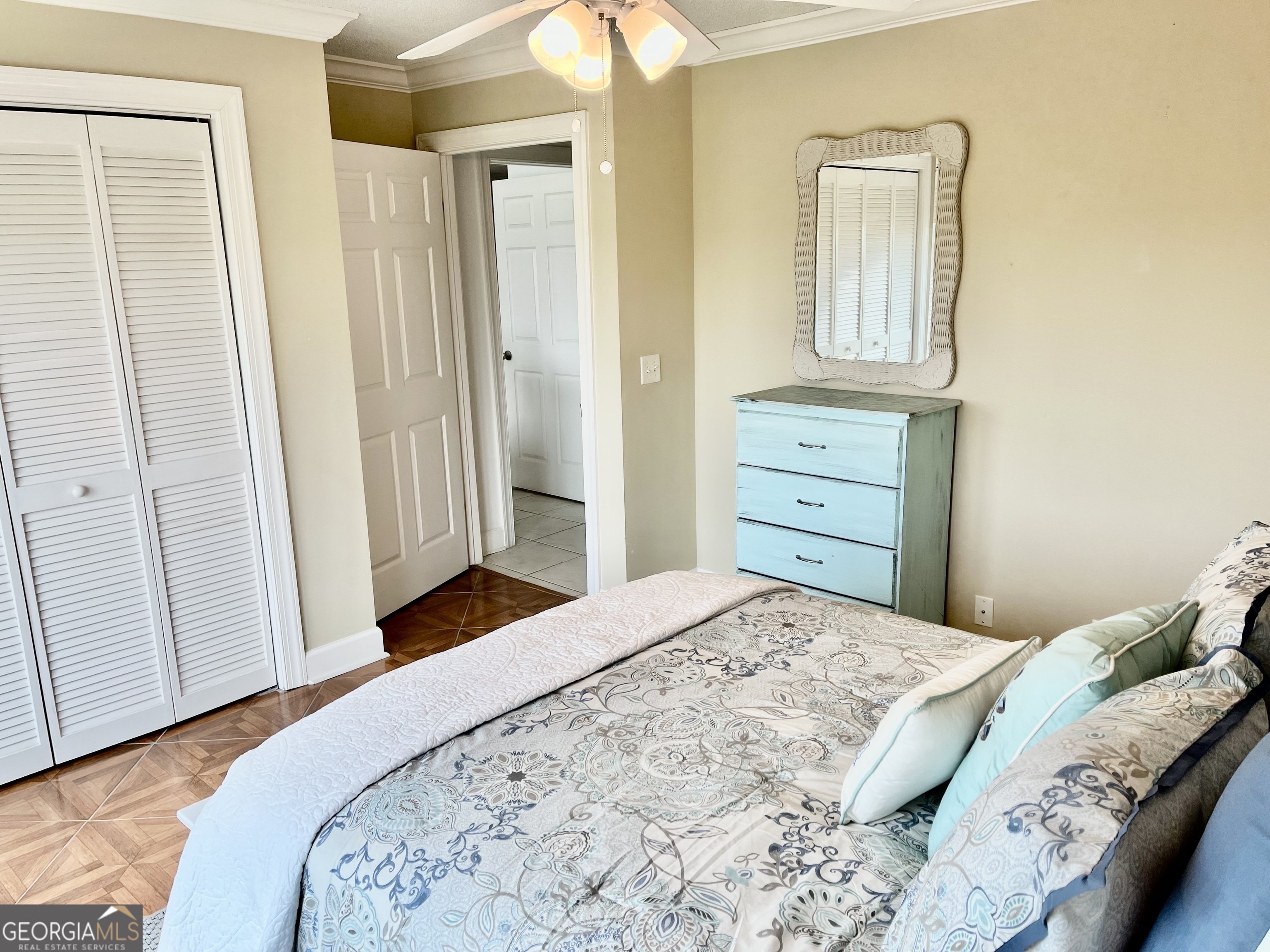 372 Moss Oak Circle St. Simons, GA 31522 - Photo 23 of 44 a bedroom with a bed and a dresser