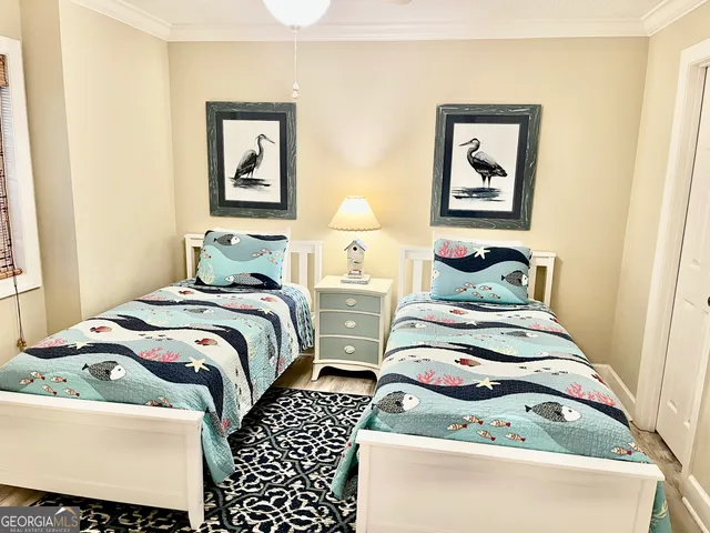 a view of a bedroom with a bed and a window