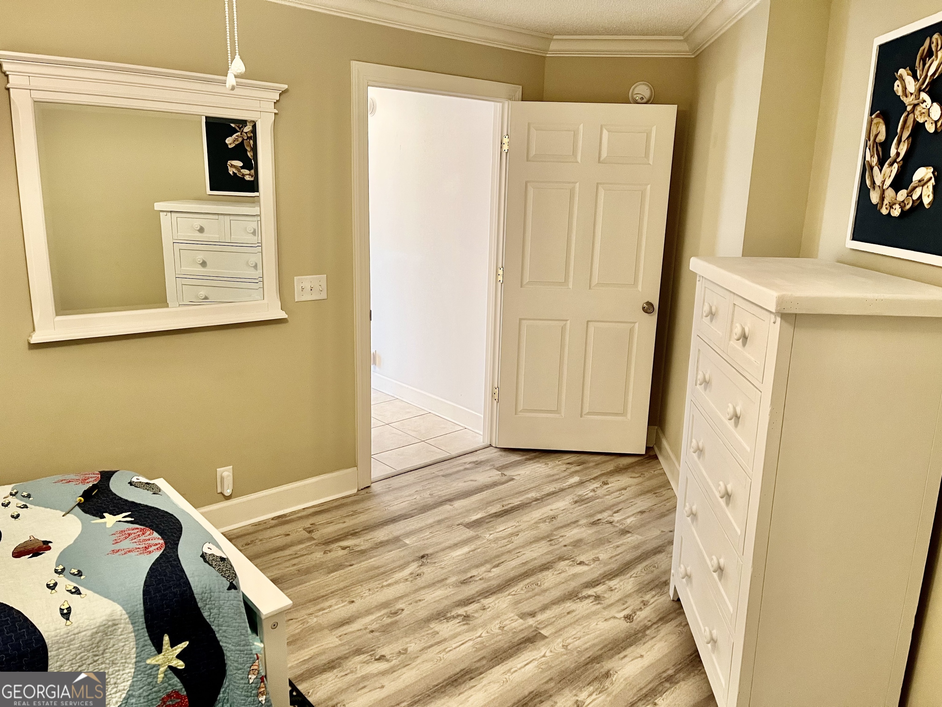 372 Moss Oak Circle St. Simons, GA 31522 - Photo 28 of 44 a view of a bedroom with a bed and a window