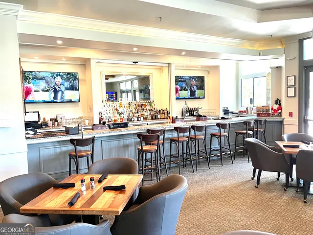 a living room with lots of chairs and a dining table with wooden floor