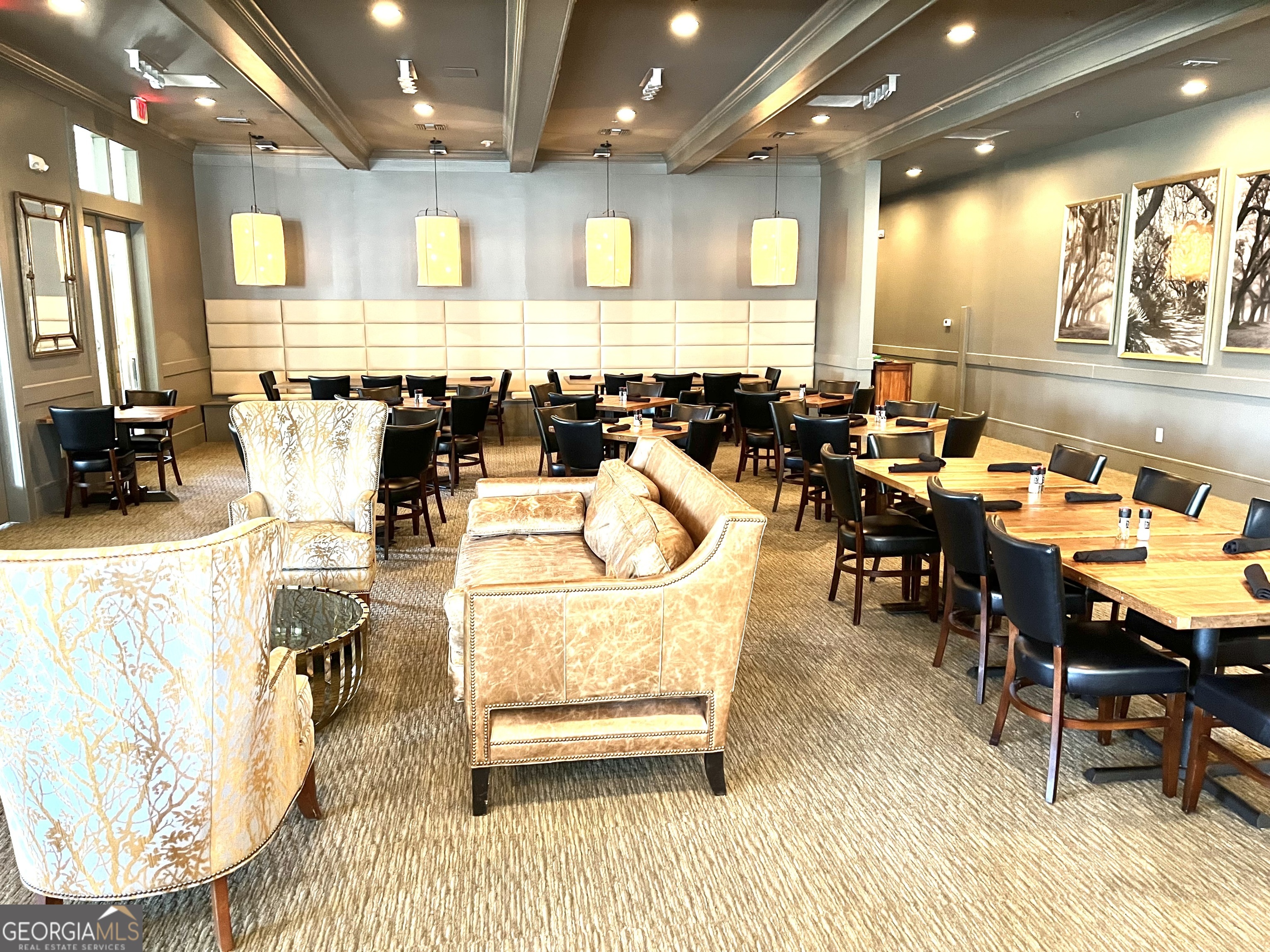 372 Moss Oak Circle St. Simons, GA 31522 - Photo 40 of 44 a living room with lots of chairs and a dining table with wooden floor