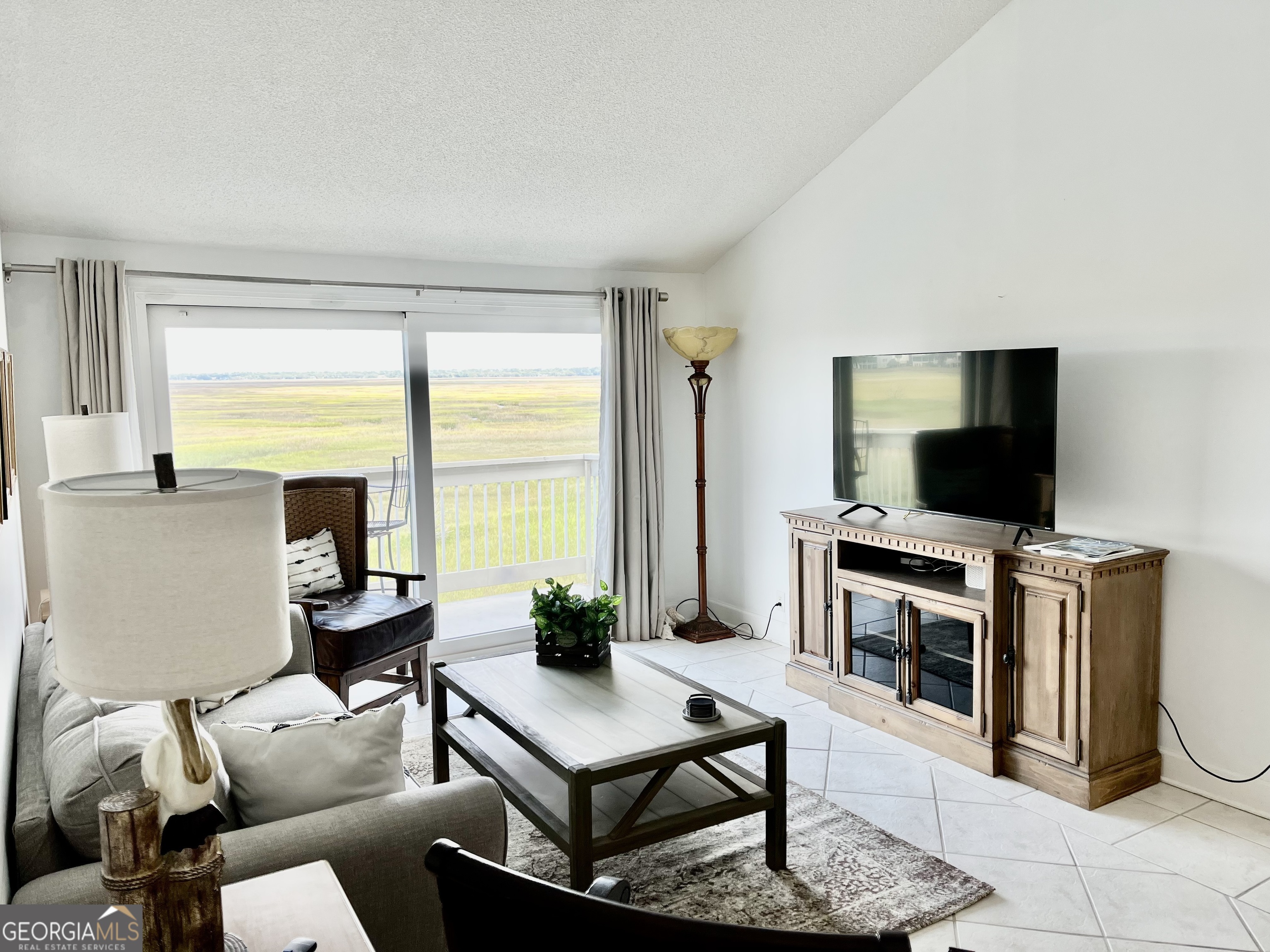 372 Moss Oak Circle St. Simons, GA 31522 - Photo 6 of 44 a living room with furniture and a flat screen tv