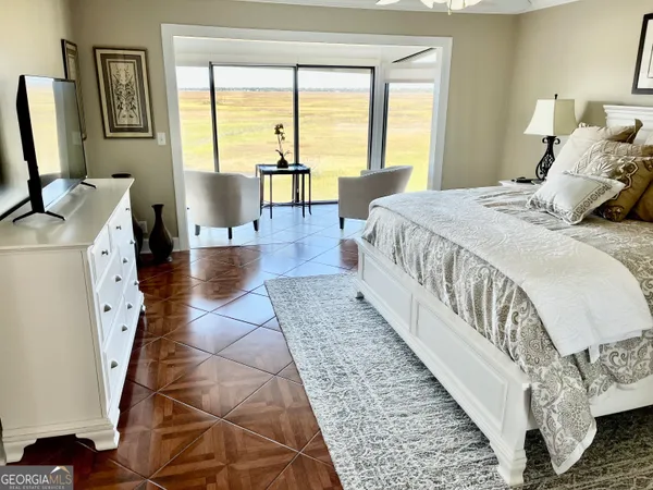 a spacious bedroom with a bed and lamp